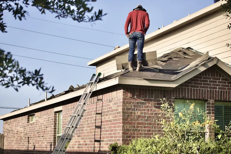 Professional roofer working on a residential roof in East Venice